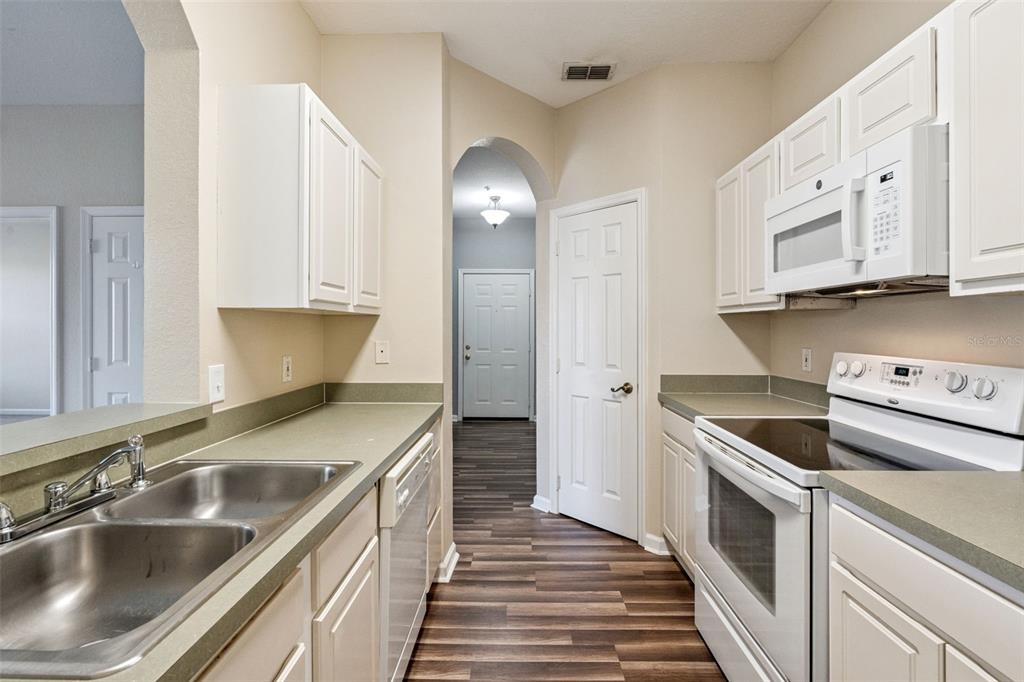 13560 Turtle Marsh Loop, Unit 21 Orlando, FL 32837 - Photo 8 of 30 a kitchen with stainless steel appliances granite countertop a sink and a stove