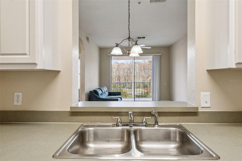 13560 Turtle Marsh Loop, Unit 21 Orlando, FL 32837 - Photo 10 of 30 a view with a sink and chandelier