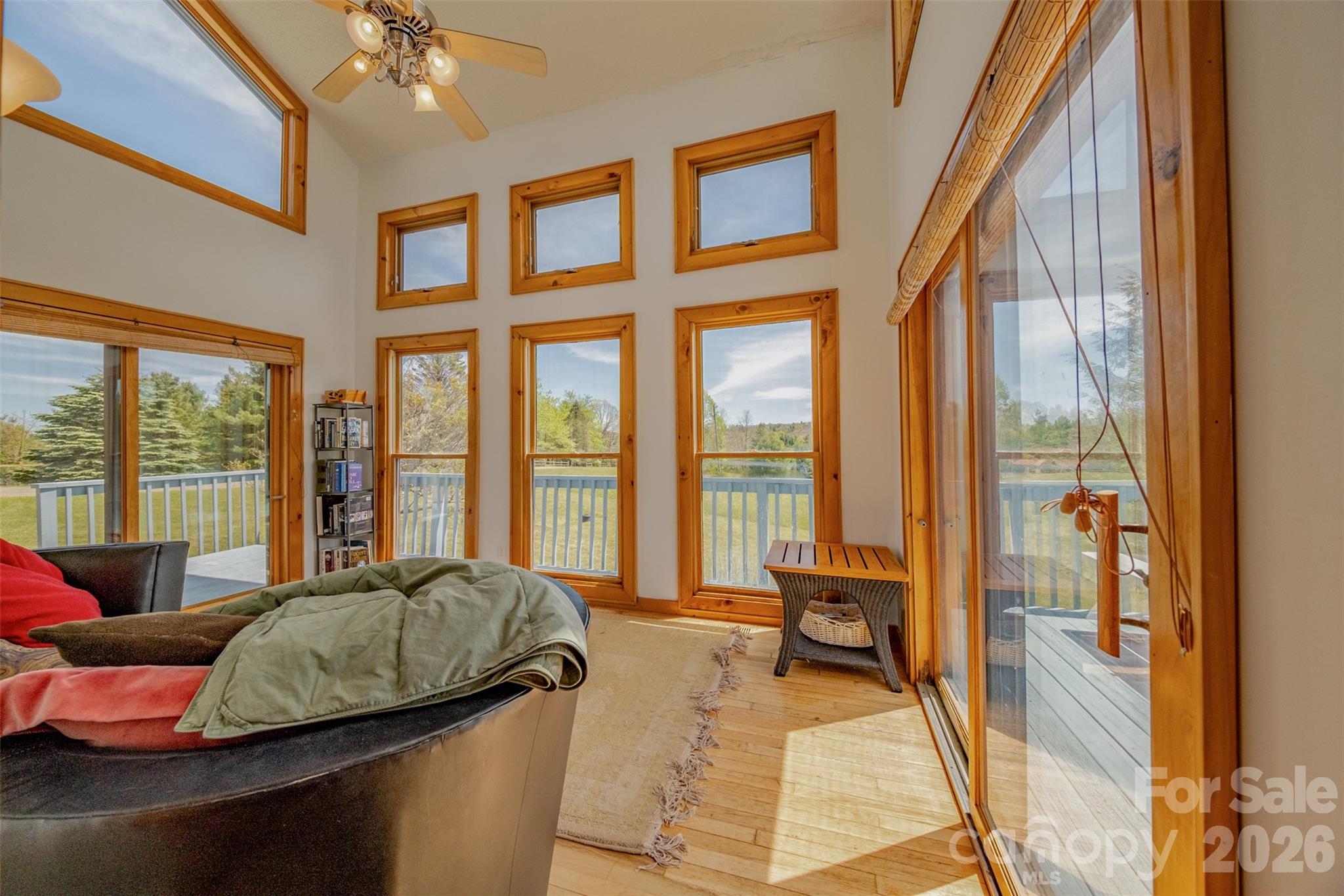 216 Deer Track Lane Sparta, NC 28675 - Photo 11 of 44 a living room with furniture and floor to ceiling windows