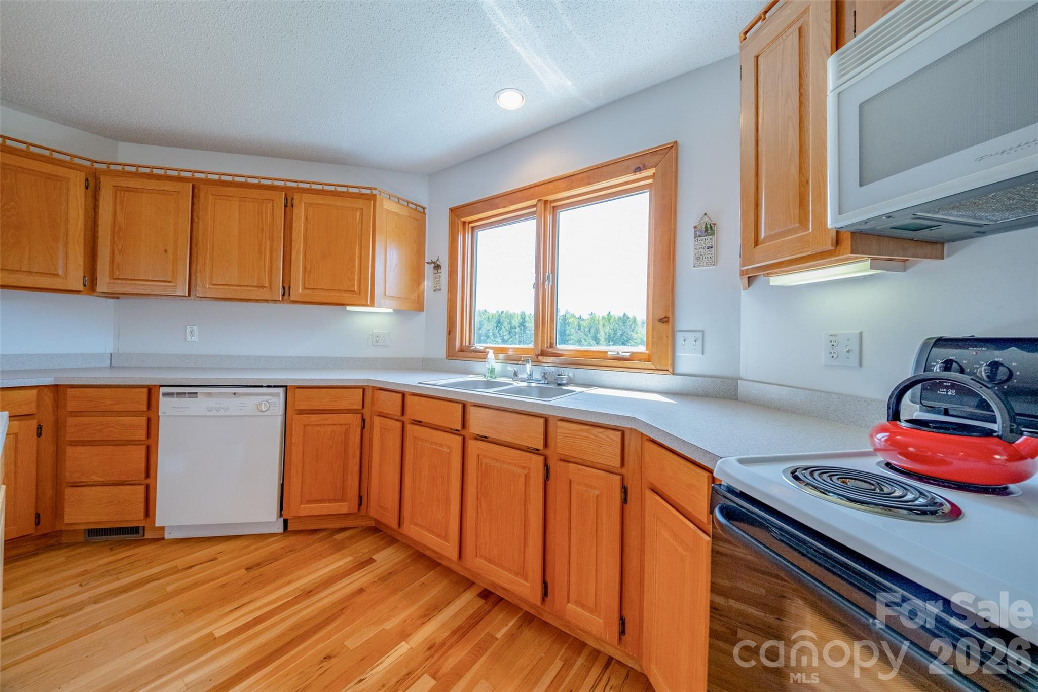 216 Deer Track Lane Sparta, NC 28675 - Photo 17 of 44 a kitchen with stainless steel appliances granite countertop a sink stove and cabinets