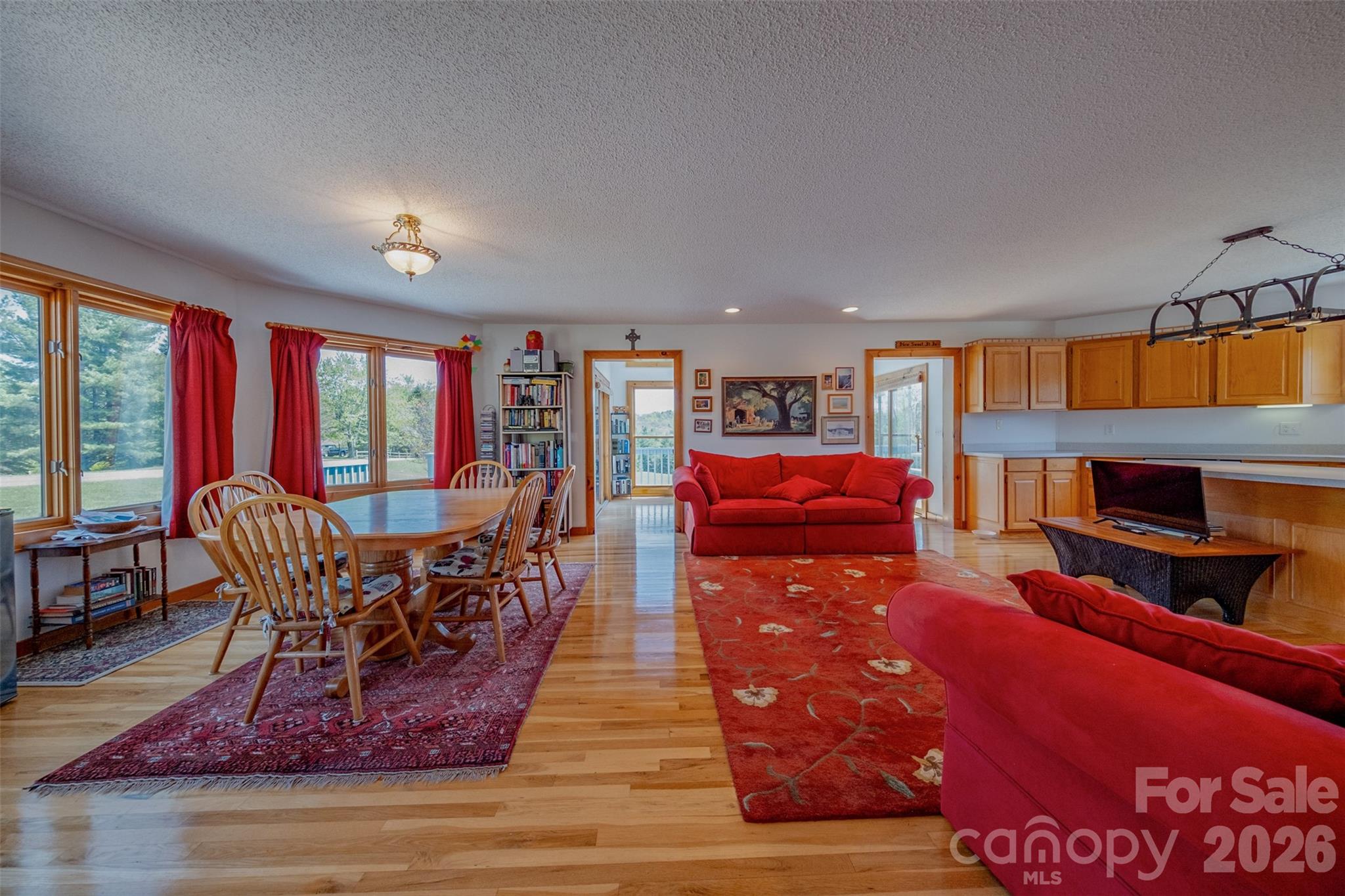 216 Deer Track Lane Sparta, NC 28675 - Photo 21 of 44 a living room with furniture a fireplace and large windows