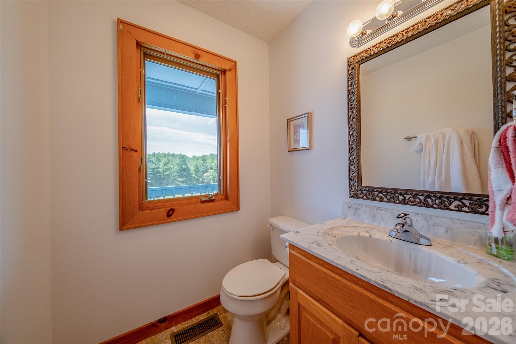 216 Deer Track Lane Sparta, NC 28675 - Photo 24 of 44 a bathroom with a granite countertop sink toilet and mirror