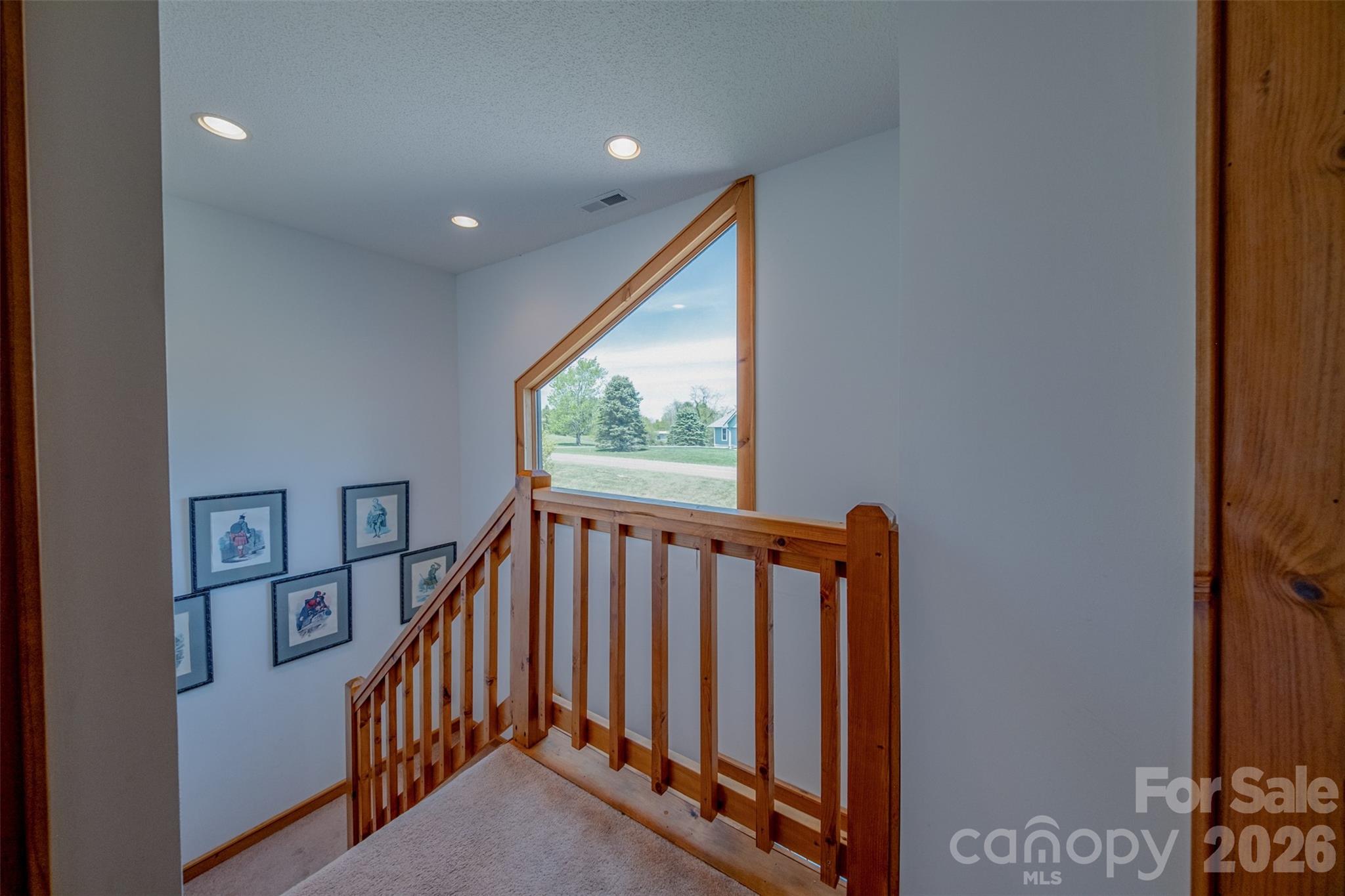 216 Deer Track Lane Sparta, NC 28675 - Photo 27 of 44 a view of a hallway with wooden floor and stairs