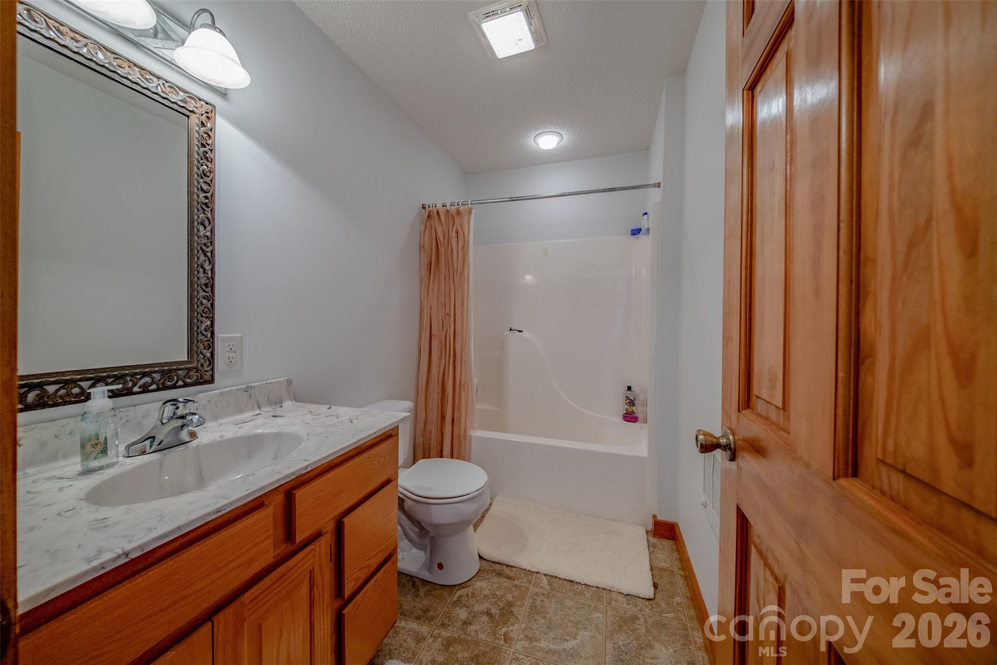 216 Deer Track Lane Sparta, NC 28675 - Photo 28 of 44 a bathroom with a sink a toilet and shower