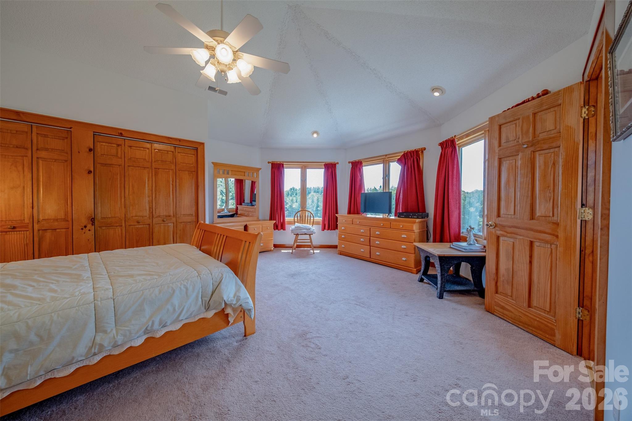 216 Deer Track Lane Sparta, NC 28675 - Photo 30 of 44 a bedroom with a bed and a chandelier