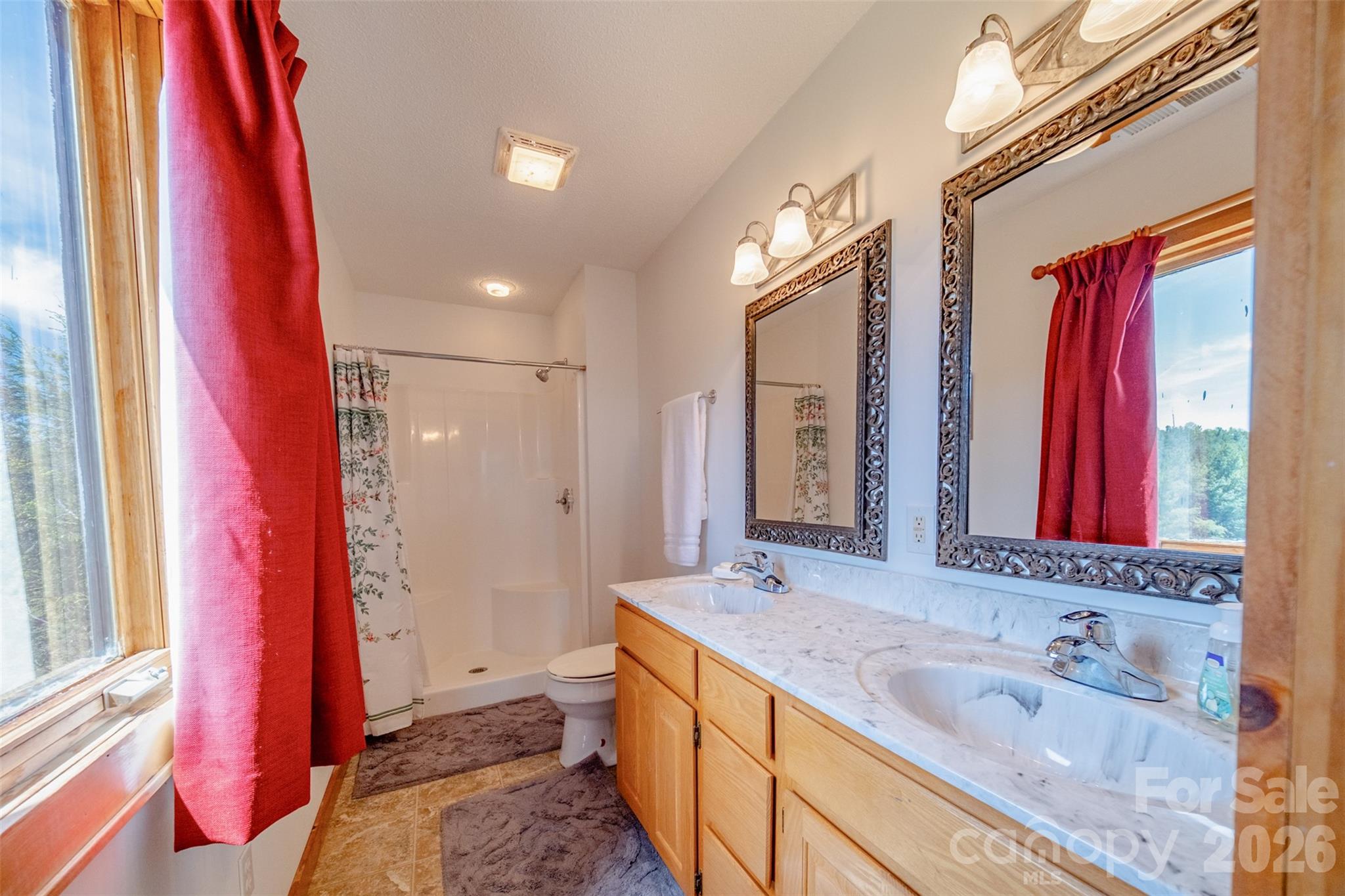 216 Deer Track Lane Sparta, NC 28675 - Photo 33 of 44 a spacious bathroom with a granite countertop sink and a mirror