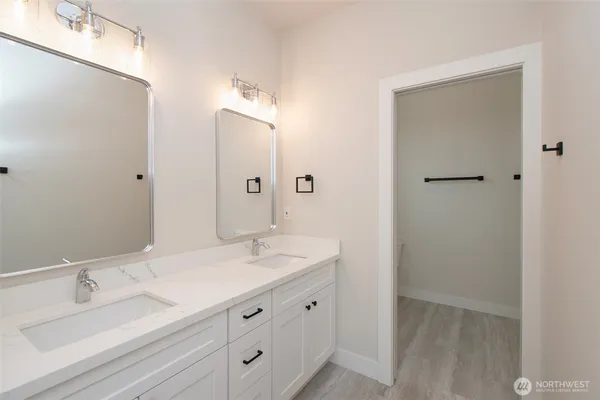 a bathroom with a double vanity sink and mirror