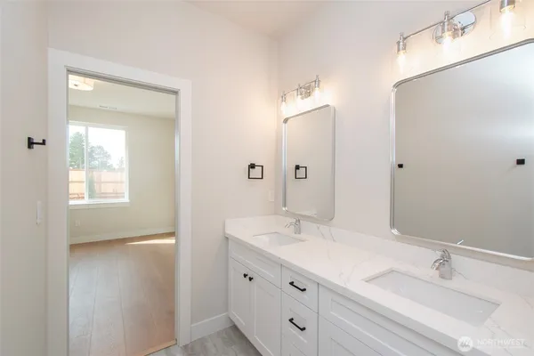a bathroom with a double vanity sink mirror and double