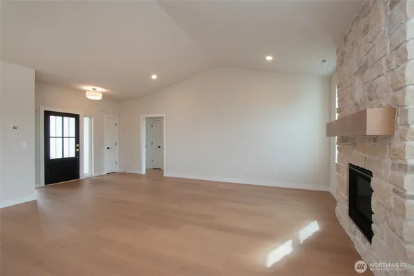 a view of an empty room with a fireplace