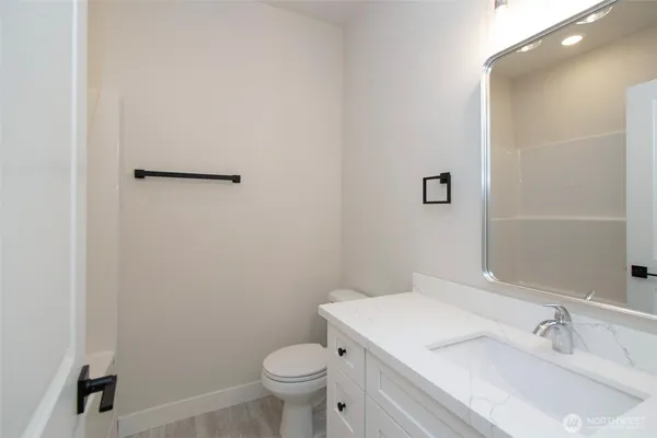 a bathroom with a sink toilet and vanity
