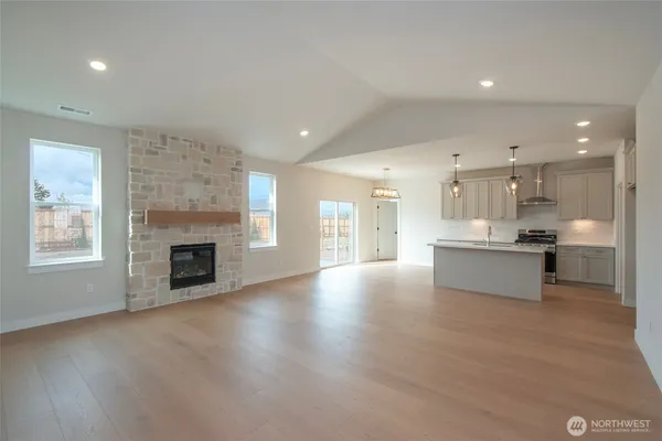 a large kitchen with a white stove top oven and cabinets