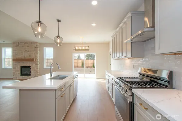 a kitchen with sink a stove and oven