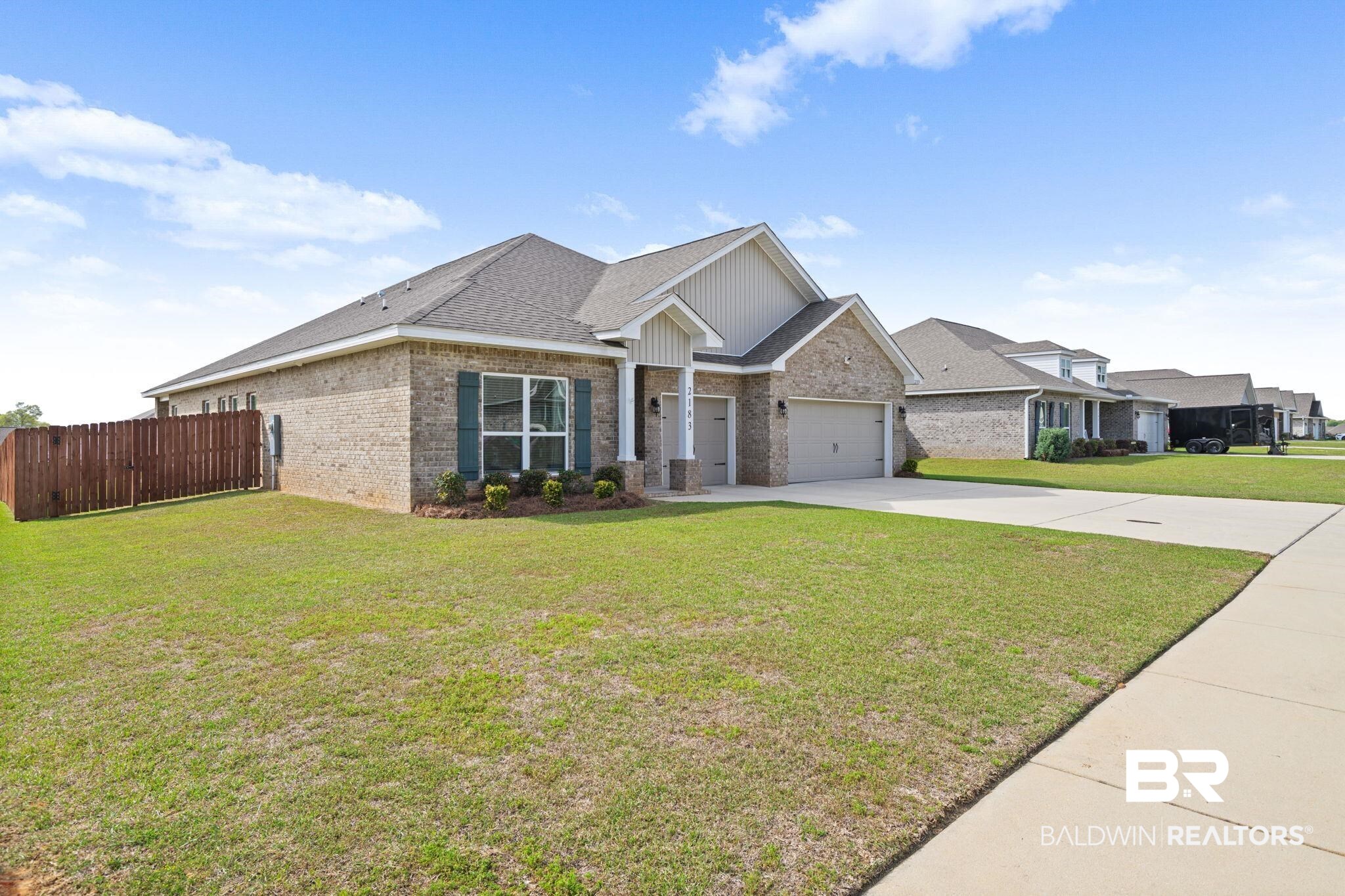 2183 Meadowview Loop Semmes, AL 36575 - Photo 5 of 58 Craftsman house with brick siding, a shingled roof, driveway, and a garage