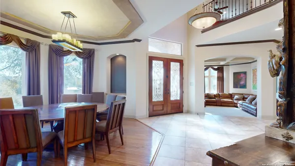a living room with furniture a fireplace and a large window