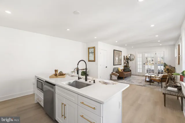 a kitchen with sink and white cabinets