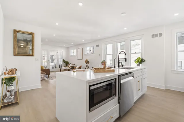 a kitchen with stainless steel appliances a stove a sink and a refrigerator