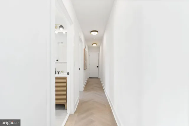 a view of a room with walk in closet with wooden floor