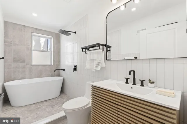 a bathroom with a sink a toilet and bathtub