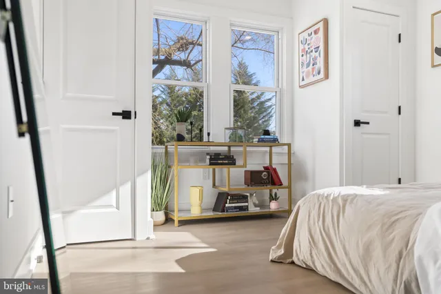 a bedroom with a bed and a large window