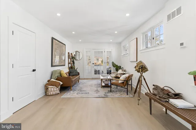 a living room with furniture gym equipment and a chandelier