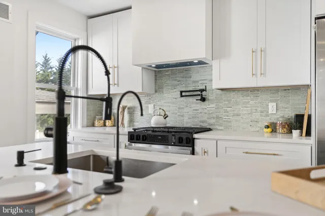a kitchen with stainless steel appliances granite countertop a white wooden cabinets and a granite counter tops