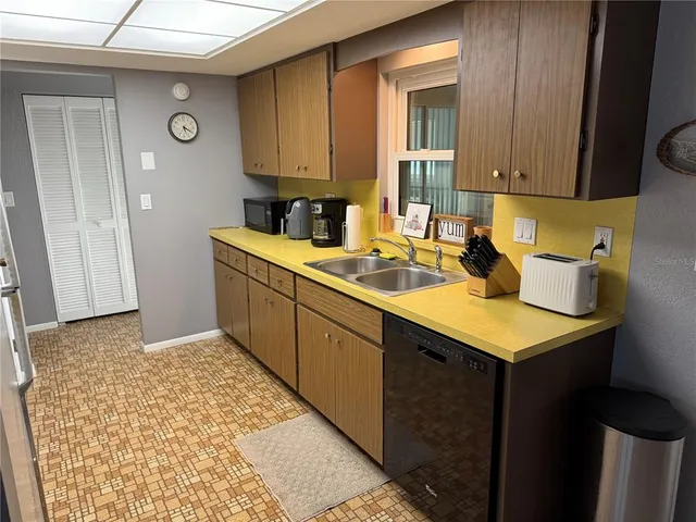a kitchen with a sink stove and cabinets
