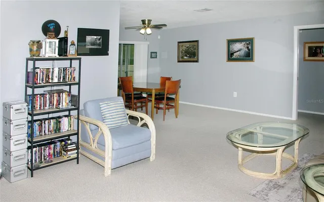 a living room with furniture and a book shelf