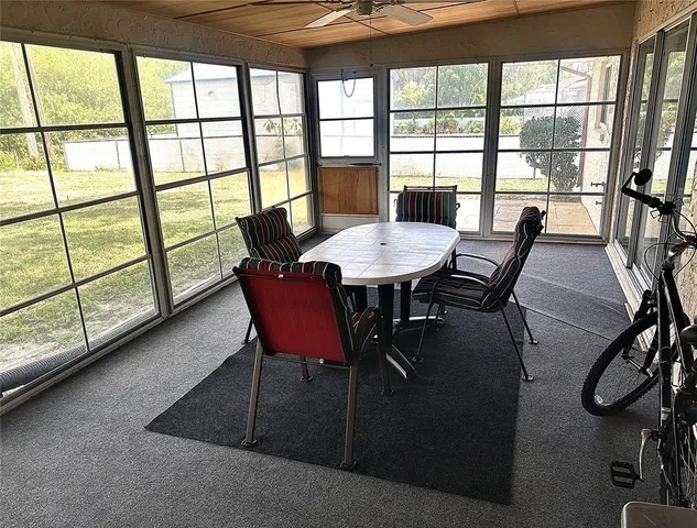 a view of a dining room with furniture window and outside view