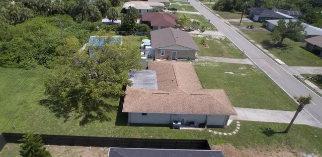 an aerial view of a house with a yard