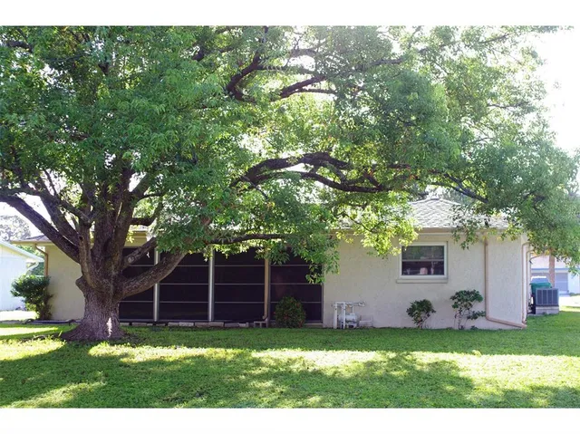 a view of a yard with a house and a tree