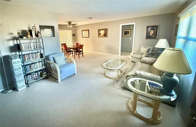 a living room with furniture a couch and a bookshelf