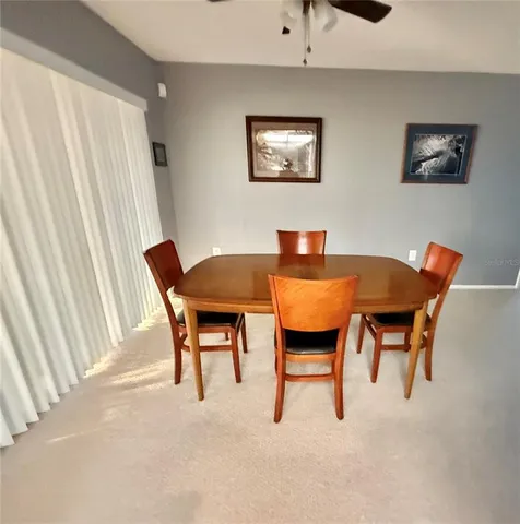 a view of a dining room with furniture and a window