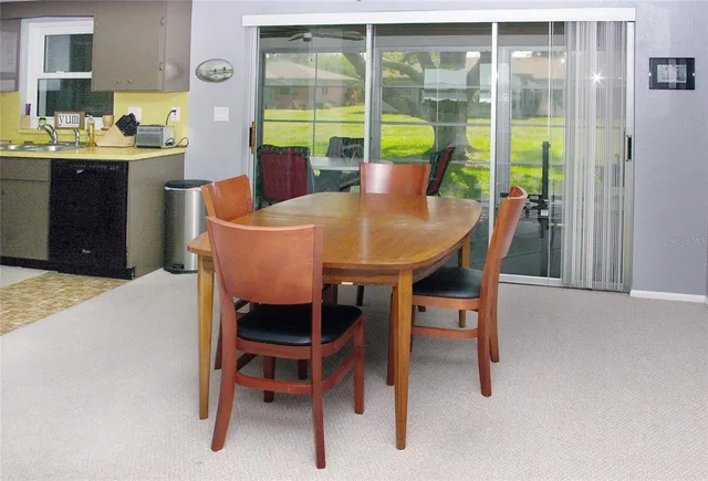 a view of a dining room with furniture and a window