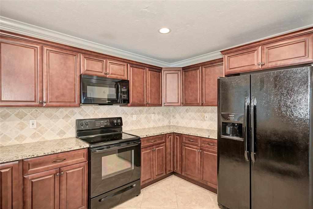 1330 Georgetowne Circle Sarasota, FL 34232 - Photo 15 of 46 a kitchen with a refrigerator stove and microwave