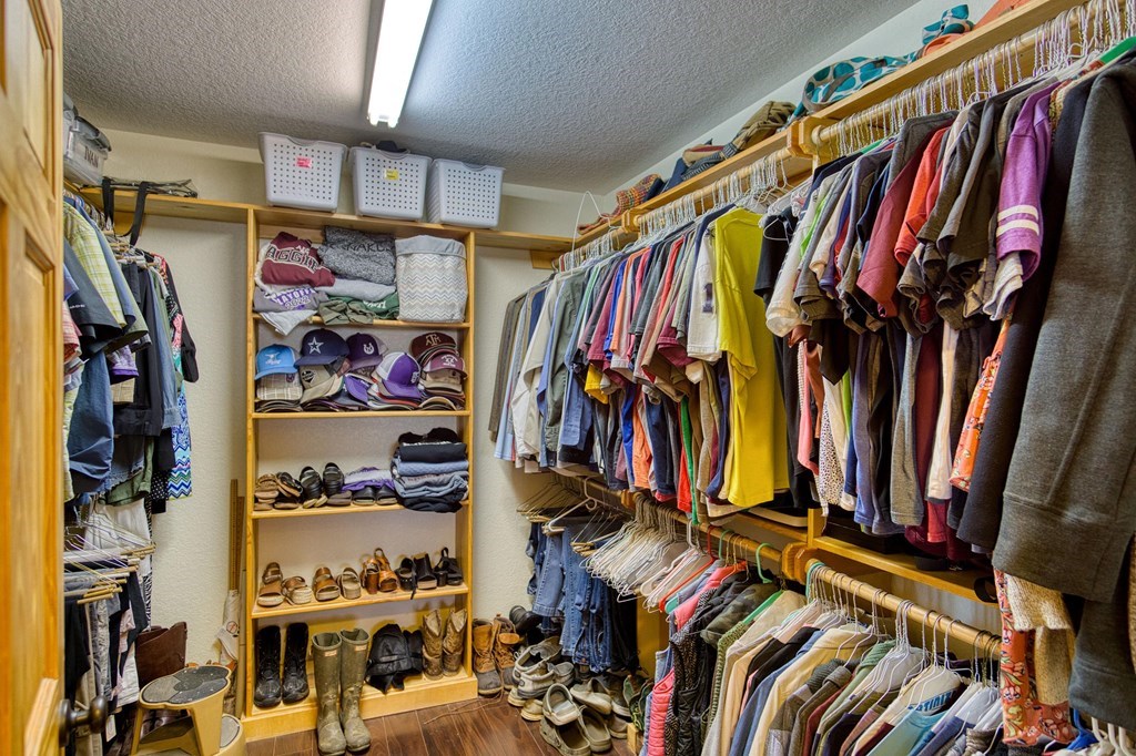 6446 Blackjack Road Fredonia, TX 76842 - Photo 20 of 48 a view of walk in closet with clothes and shoes