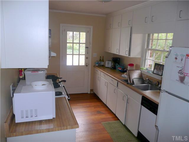 1706 Pineview Street Raleigh, NC 27608 - Photo 7 of 12 a kitchen with granite countertop a sink dishwasher stove and cabinets