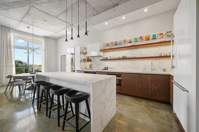 a kitchen with kitchen island a breakfast area