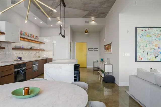 a large white kitchen with a large window