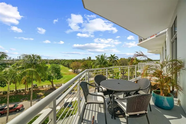 a balcony with table and chairs