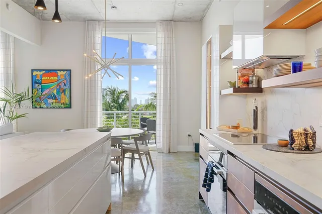 a kitchen with a table chairs and a wooden floor