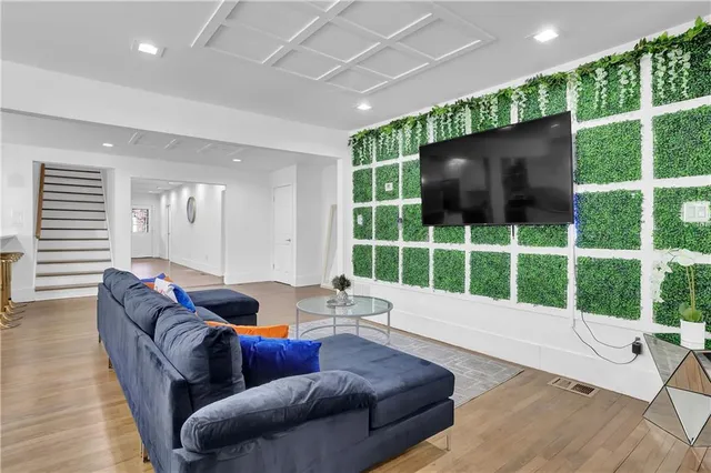 a living room with furniture window and a flat screen tv