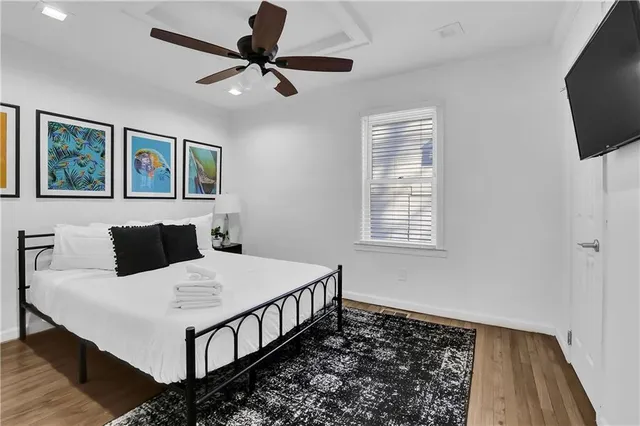 a bedroom with a bed and a flat screen tv