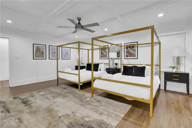 a spacious bedroom with a bed and a desk