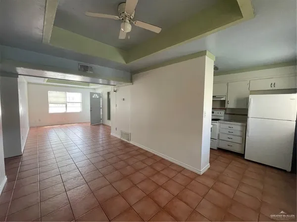 a view of a refrigerator in kitchen and wooden floor