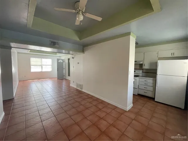 a view of a refrigerator in kitchen and wooden floor
