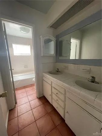 a bathroom with a sink a toilet and a shower