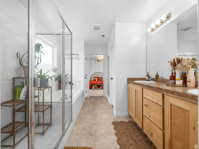 256 West Horizon Loop Payson, UT 84651 - Photo 18 of 33 Full bath featuring ensuite bath, double vanity, a shower stall, and a garden tub