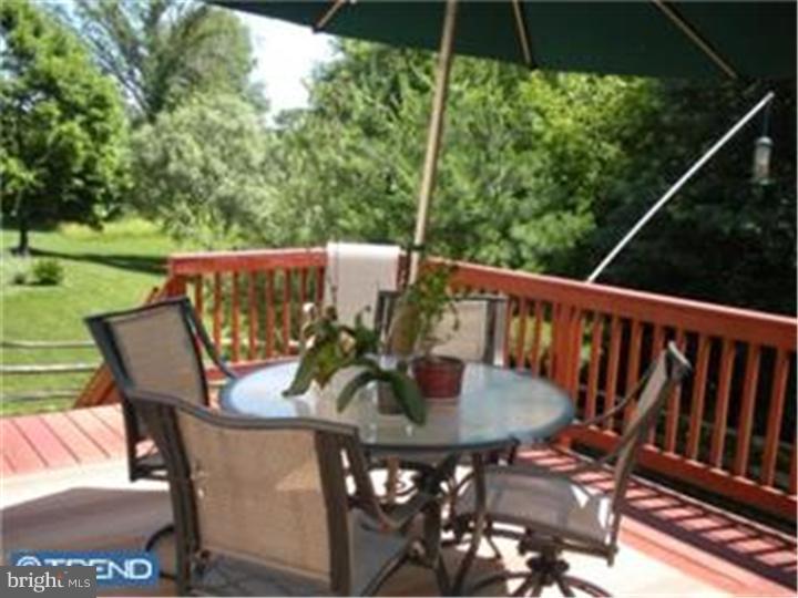 5 Coburn Road Pennington, NJ 08534 - Photo 21 of 25 a view of balcony with furniture and umbrella