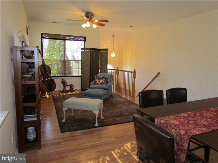 5 Coburn Road Pennington, NJ 08534 - Photo 5 of 25 a living room with furniture a flat screen tv and a fireplace