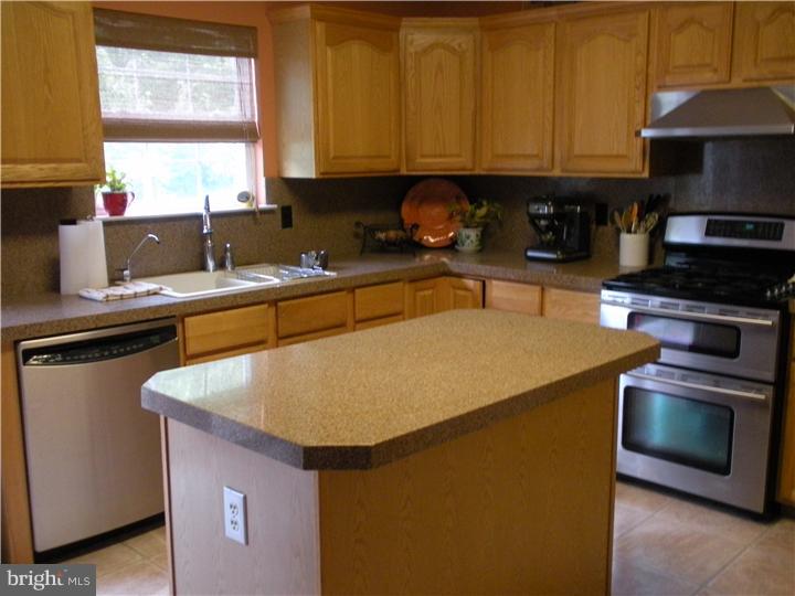 5 Coburn Road Pennington, NJ 08534 - Photo 7 of 25 a kitchen with stainless steel appliances granite countertop a sink a stove and a microwave
